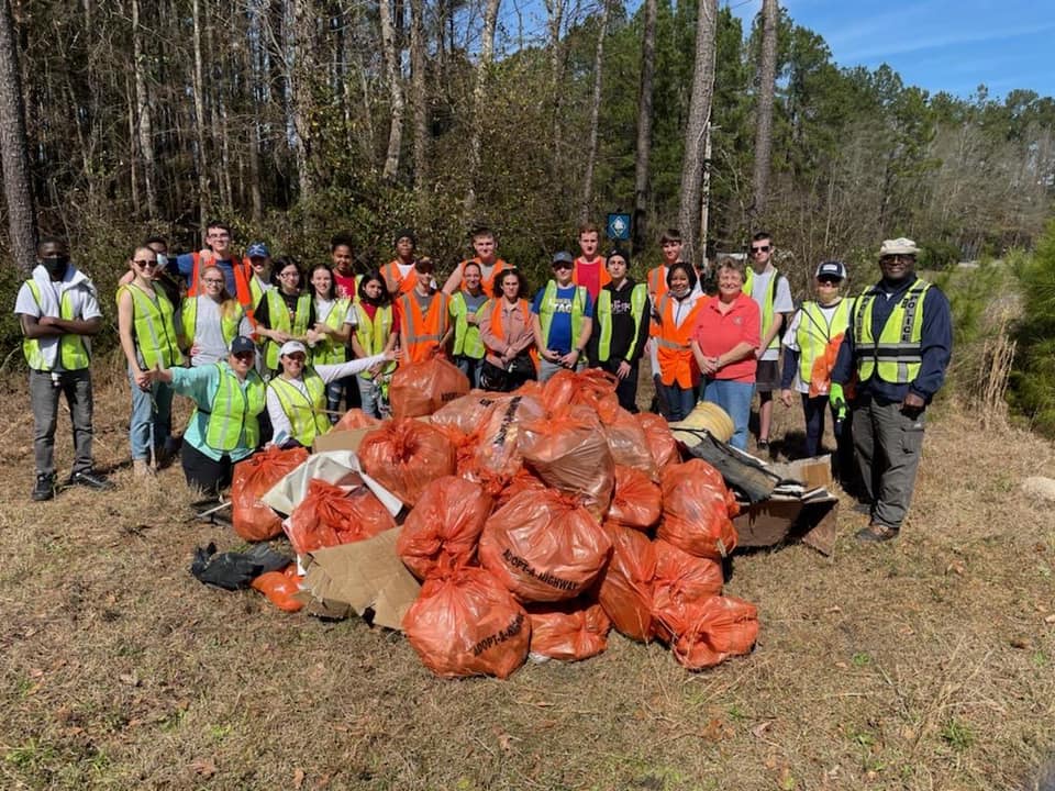 Group of people cleaning up litter